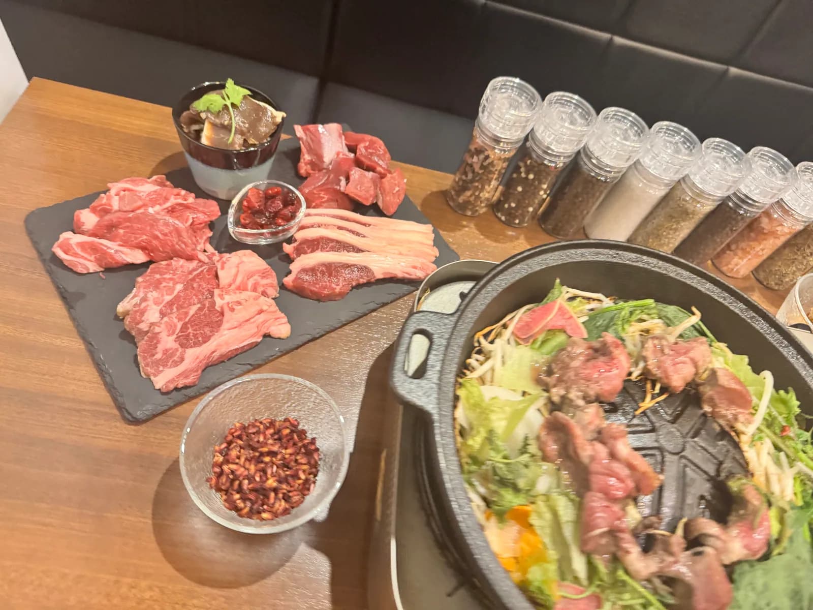 A Jingisukan grill at the Shibuya store: lamb grilling on the domed iron pan at the center, with vegetables laid around it